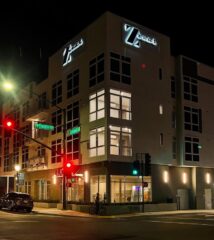 Modern building with illuminated signage at night.