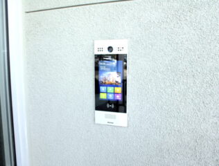 Modern video intercom on textured wall
