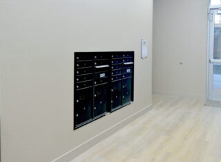 Row of black mailboxes in hallway