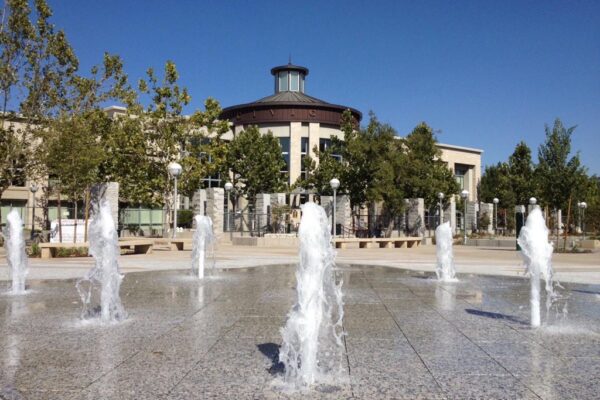 Roseville community center water spouting from ground for kids to run through in the summer