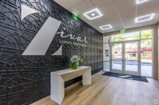 Modern luxury apartment lobby with decorative wall.