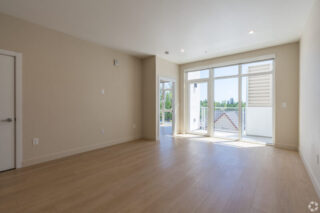 Empty room with wooden floor and large window