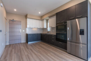 Modern kitchen with stainless steel appliances.