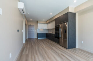 Modern kitchen interior with sleek appliances and flooring.