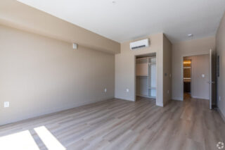 Empty room with hardwood floors and closet