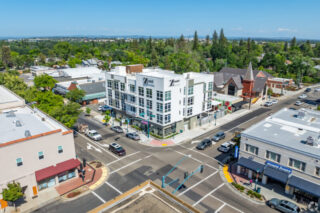 Aerial view of urban intersection with buildings.