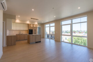 Modern open-concept kitchen with large windows.