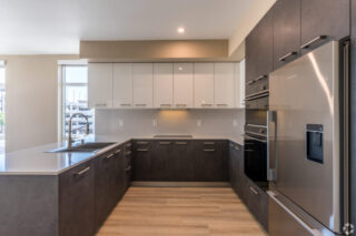 Modern kitchen with stainless steel appliances.