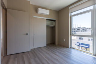 Empty room with open closet and street view
