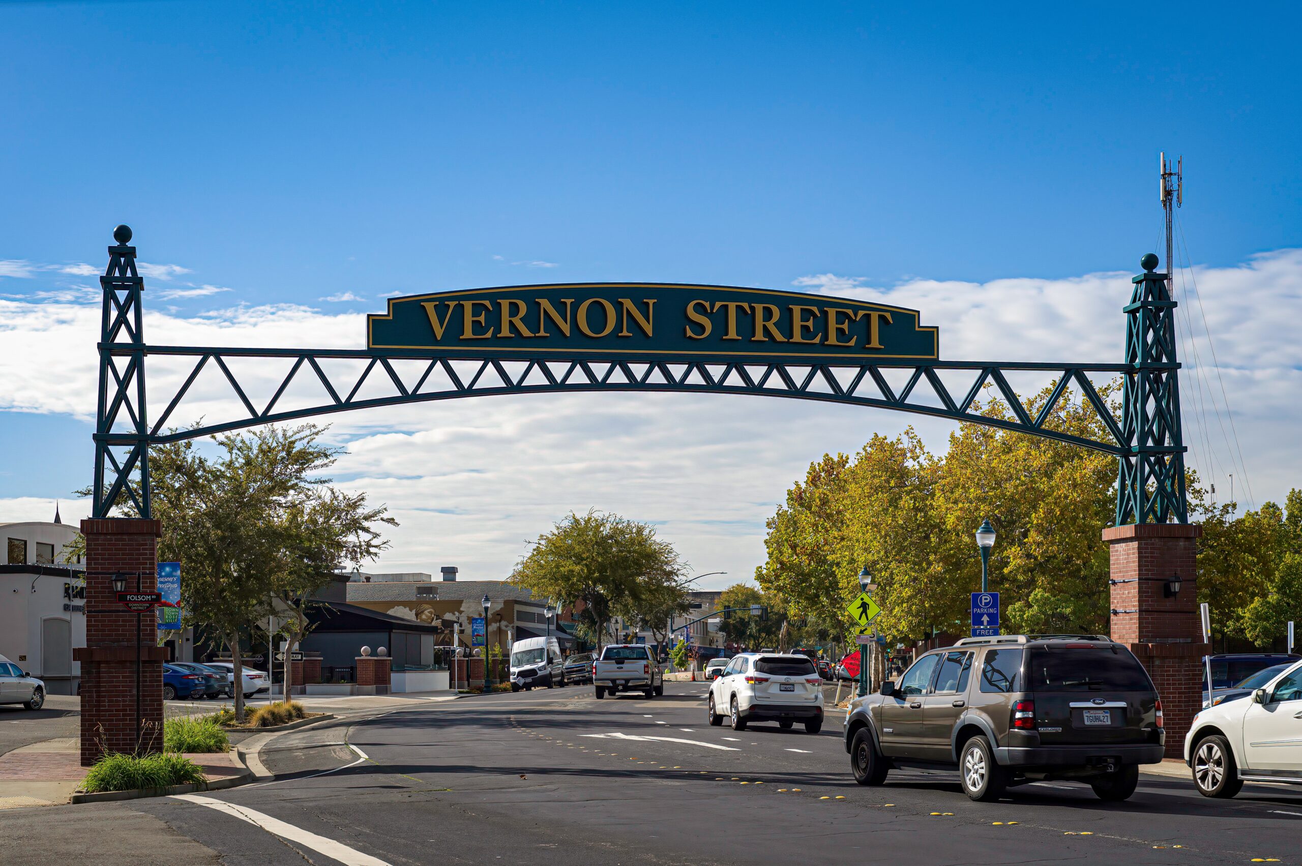 Vernon Street sign over road with cars.
